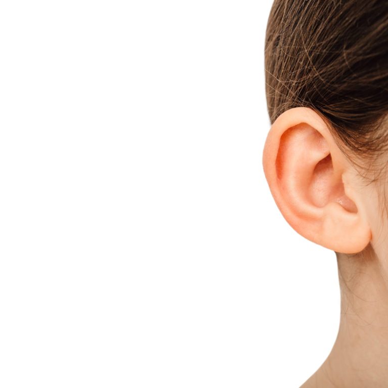 Child ear close-up isolated on a white background. Treatment and hearing test, hearing exam concept