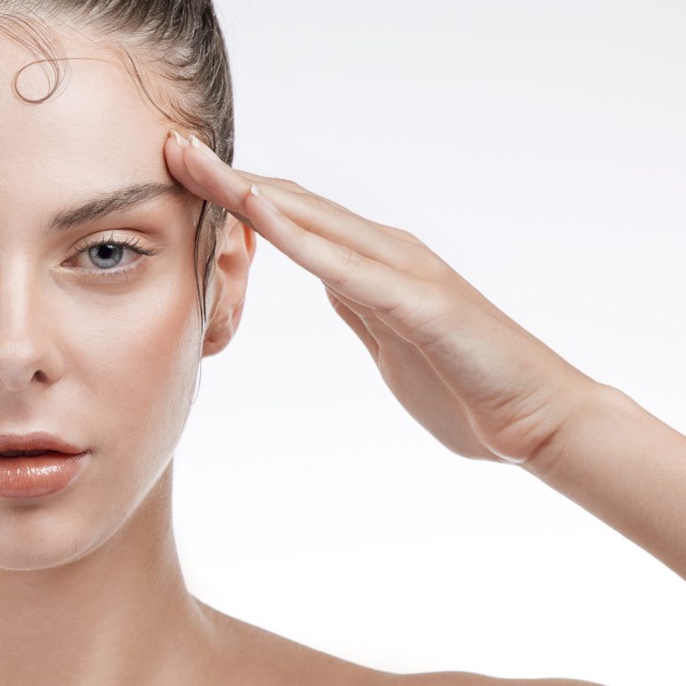 Portrait, woman and face with closeup in studio on white background for beauty mock up. Female model, salute and serious expression for self care, edges and treatment for health, glow and texture.