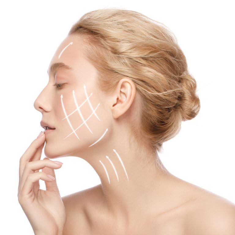 Face lift and anti aging concept. Side portrait of beautiful woman with perfect clean skin with arrows on face, isolated on white background