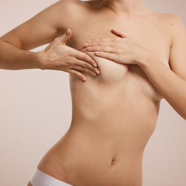 Breast cancer concept - woman checking her breast